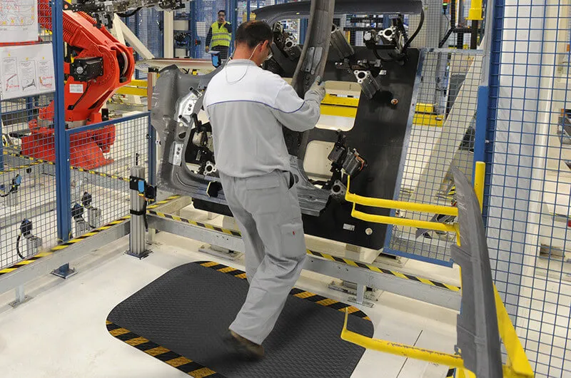 Ergonomic floor mat with safety striped edge