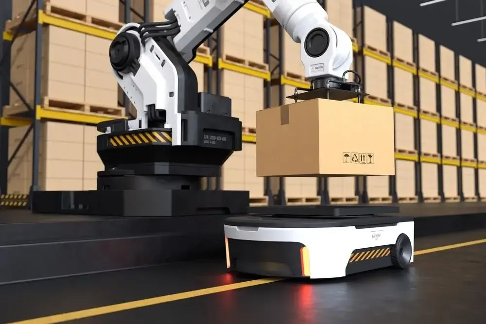 Robotic arm placing a box on an AGV